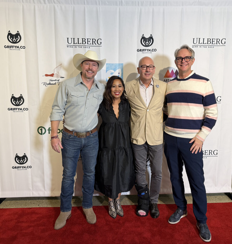 Group of four people at a red carpet event.