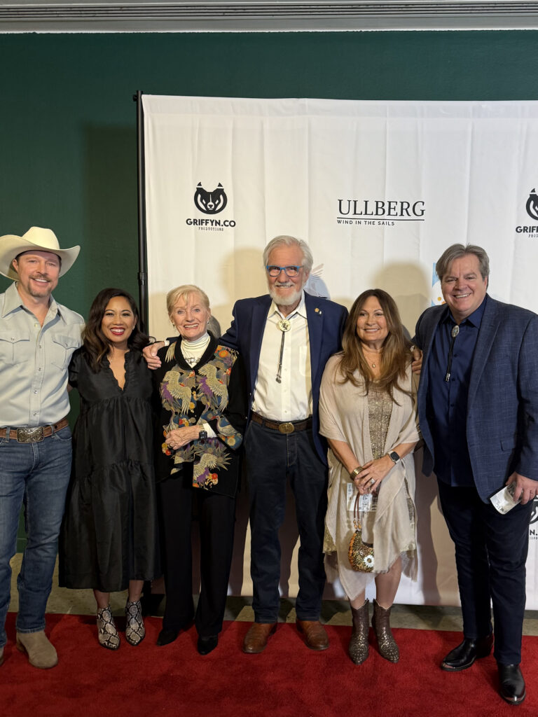 Group of six people posing at event