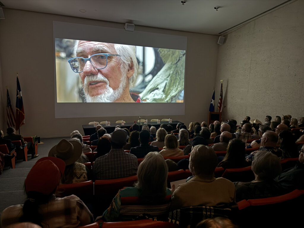 Audience watching a movie in a theater.