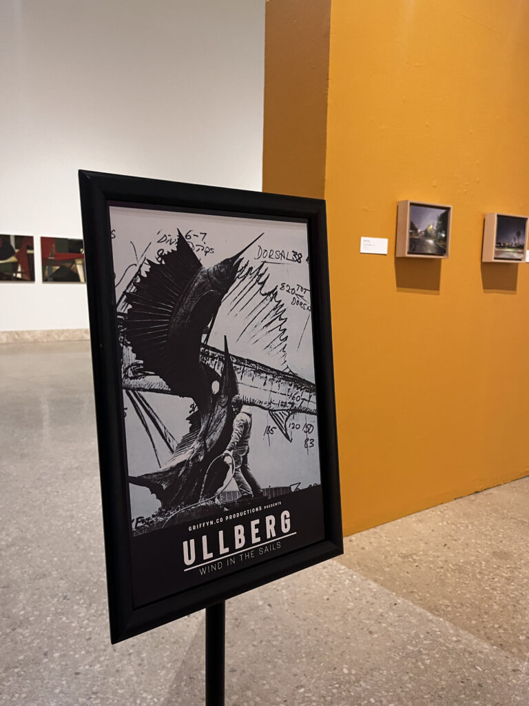 Art exhibit poster in gallery setting.