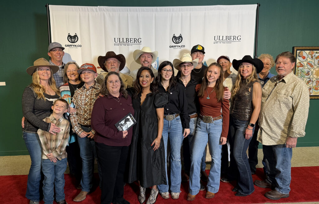 Group of people posing on a red carpet.